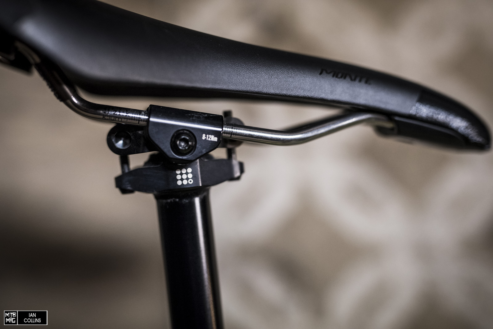 Four separate black anodized titanium screws independently secure the saddle rails.